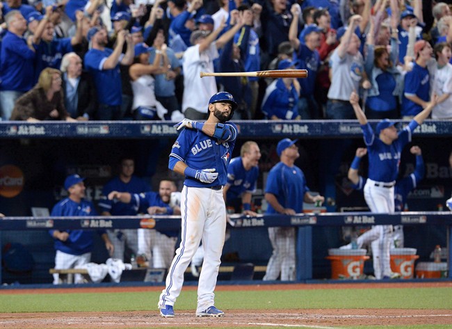 Toronto Blue Jays Jose Bautista flips his bat after hitting a three-run homer during seventh inning game 5 American League Division Series baseball action in Toronto on Wednesday, Oct. 14, 2015.