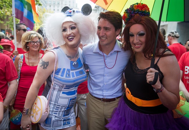 Liberal Leader Justin Trudeau stands for a photo with revellers before marching in the Vancouver Pride Parade speaks in Vancouver, B.C., on Sunday August 2, 2015. 