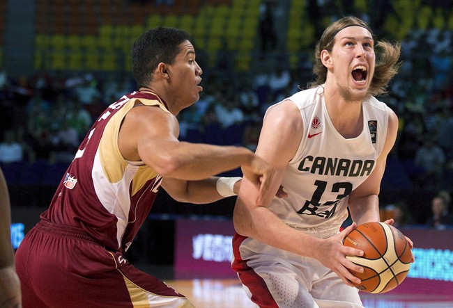 Canada's Kelly Olynyk, right, looks to shoot under pressure from Venezuela's Windi Graterol, during a FIBA Americas Championship basketball game in Mexico City, Friday, Sept. 11, 2015.