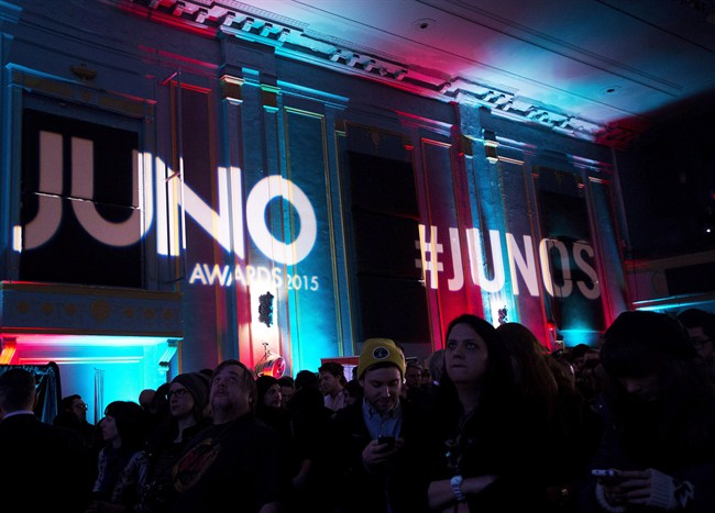 People watch as the 2015 Juno award nominations are presented during a press conference in Toronto on Tuesday, January 27, 2015. 