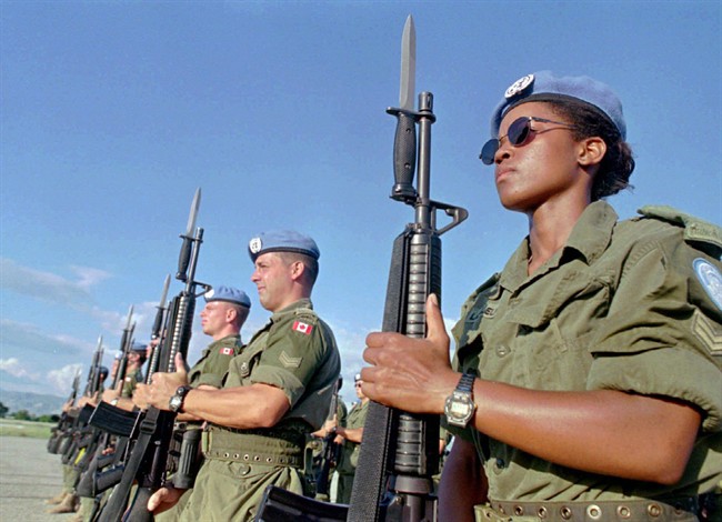 Canadian peacekeepers prepare for a parade at Maple Leaf Camp in, Haiti in 1997. The Trudeau government has promised to get Canada back into the peacekeeping business, but has yet to take any concrete action.