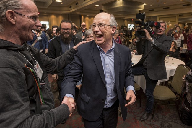 Gary Burrill, centre, celebrates with supporters following his election as leader of the Nova Scotia New Democratic Party in February. Burrill doesn't have a seat in the legislature and says he won't run until the premier calls a general election.
