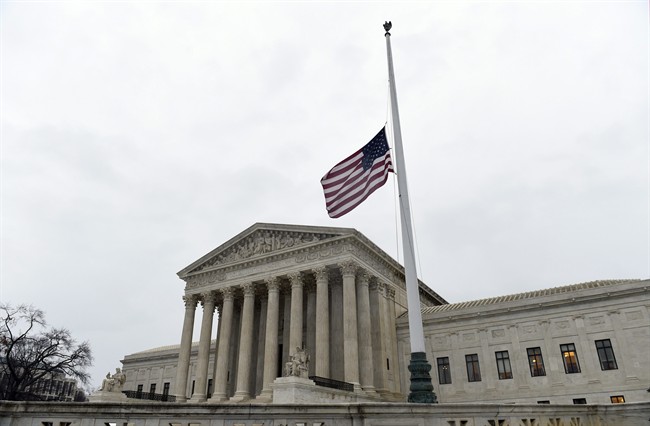 The flag flies at half-staff outside the Supreme Court in Washington, Tuesday, Feb. 16, 2016, following the death of Supreme Court Justice Antonin Scalia over the weekend.
