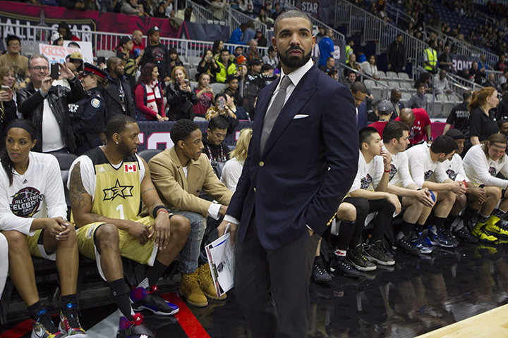 Drake stands in front of Team Canada's bench before the start of the NBA celebrity all-star game in Toronto on Friday February 12, 2016. 