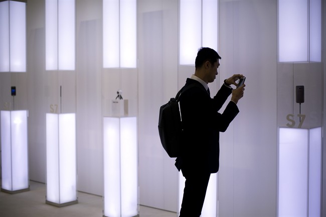 A man uses his mobile to photograph the new Galaxy S7 at the Mobile World Congress wireless show, in Barcelona, Spain, Monday, Feb. 22, 2016. 