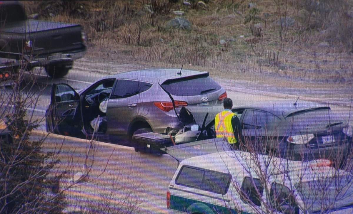 An official examines two of the four cars involved in a pileup on Hwy. 111 northbound. The collision happened in Dartmouth and blocked access to the MacKay bridge from Hwy. 111 on Saturday morning.