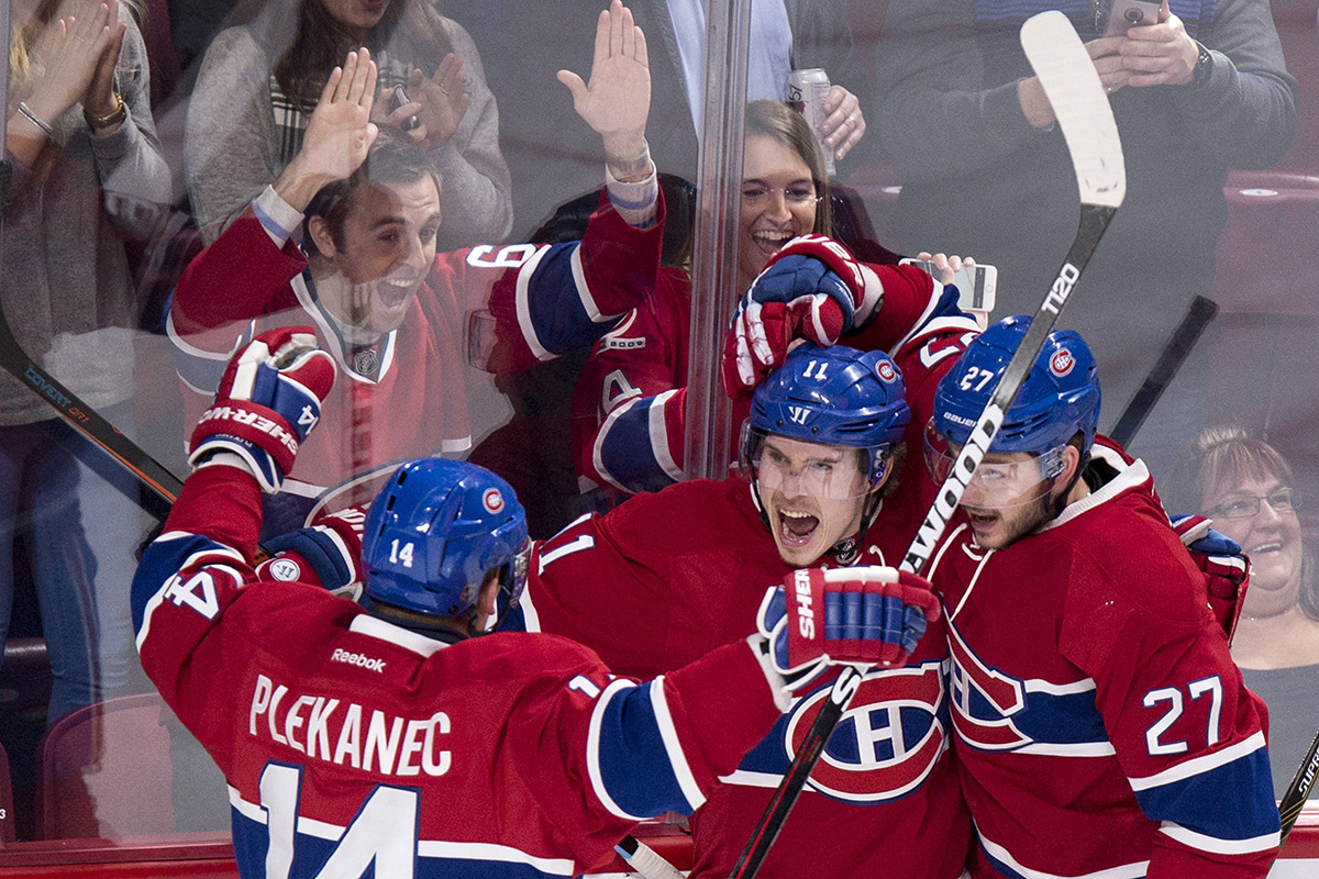 Montreal Canadiens' Brendan Gallagher celebrates his goal against the Tampa Bay Lightning with teammates Tomas Plekanec, left, and Alex Galchenyuk, right, during first period NHL hockey action Tuesday, February 9, 2016 in Montreal.