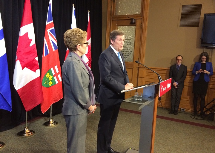 Mayor John Tory speaks to reporters alongside Premier Kathleen Wynne at Queen's Park on Feb. 22, 2016.