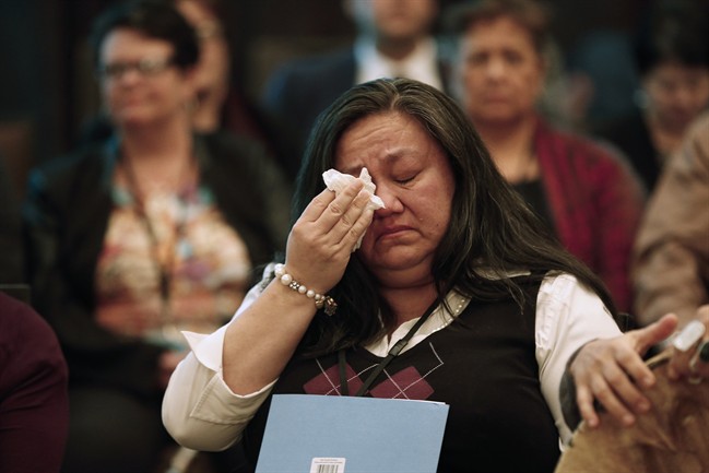 A woman wipes away a tear around a sharing circle at the 2nd National Roundtable on Missing and Murdered Indigenous Women and Girls in Winnipeg.