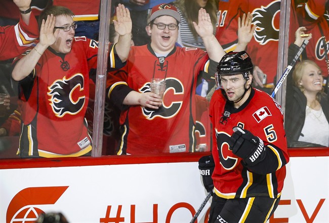 Calgary Flames' Mark Giordano celebrates his goal during second period NHL hockey action against the Carolina Hurricanes in Calgary, Wednesday, Feb. 3, 2016.