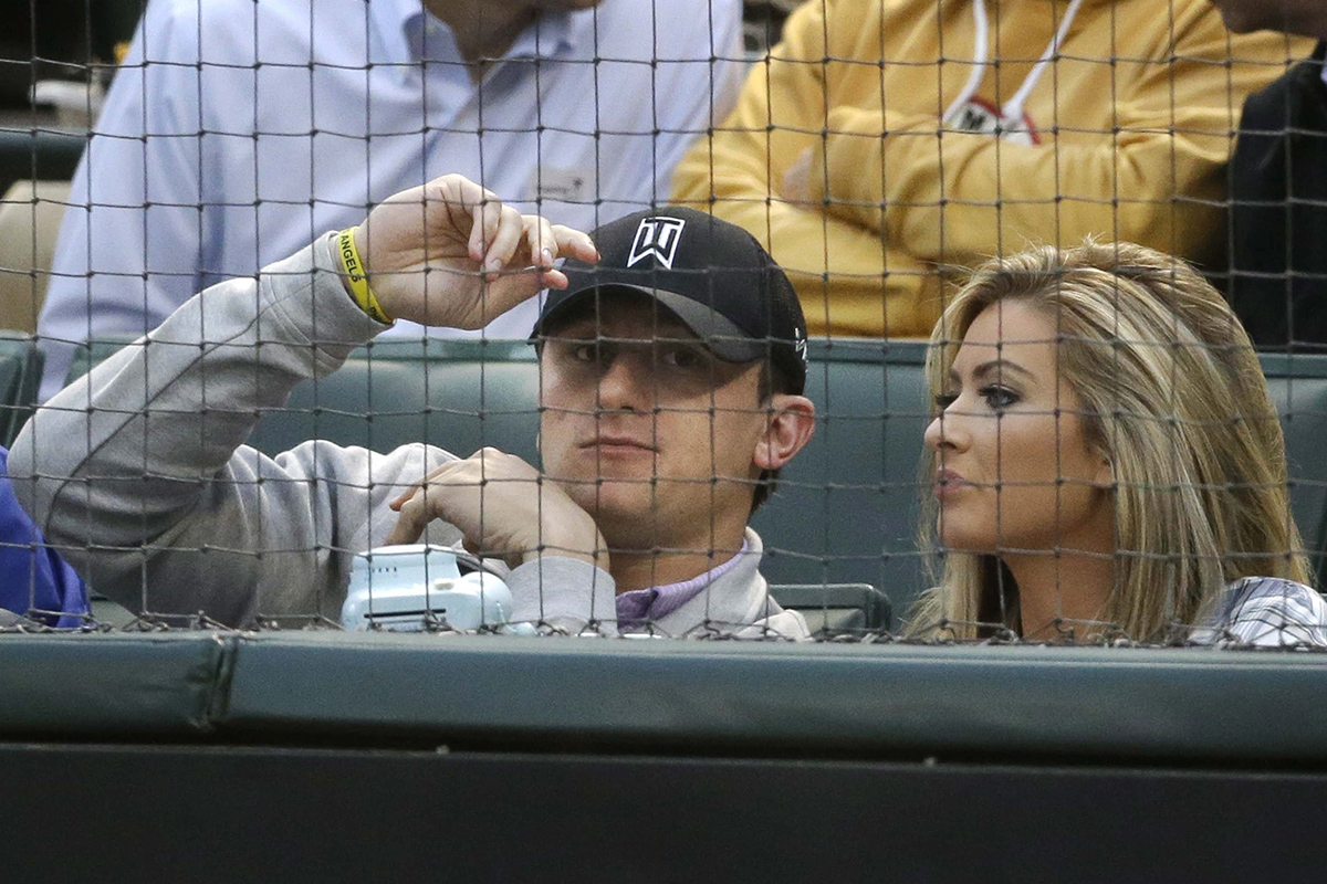 In this file photo made Tuesday, April 14, 2015, Johnny Manziel, left, sits with  Colleen Crowley during a baseball game between the Los Angeles Angels and the Texas Rangers in Arlington, Texas. 
