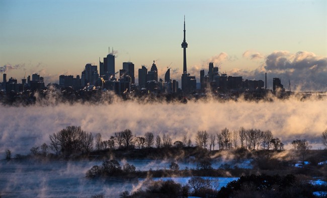 Steam rises from Lake Ontario in front of the skyline during extreme cold weather in Toronto on Saturday, February 13, 2016. THE CANADIAN PRESS/Mark Blinch.