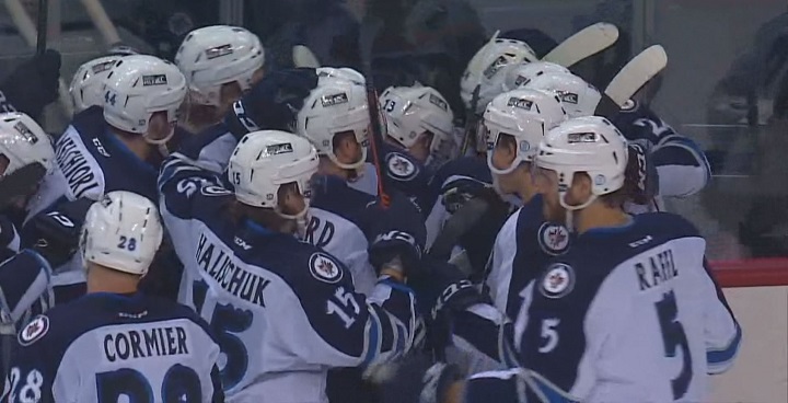 The Manitoba Moose swarm Nic Petan after he scored the overtime winner against the Toronto Marlies on Saturday, February 6, 2016.