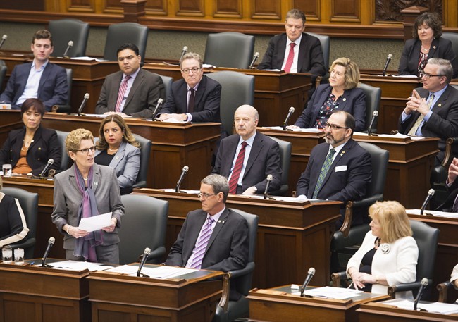 Ontario Premier Kathleen Wynne, bottom left, speaks during question period at Queen's Park in Toronto on Monday, February 22, 2016. THE CANADIAN PRESS/Nathan Denette.