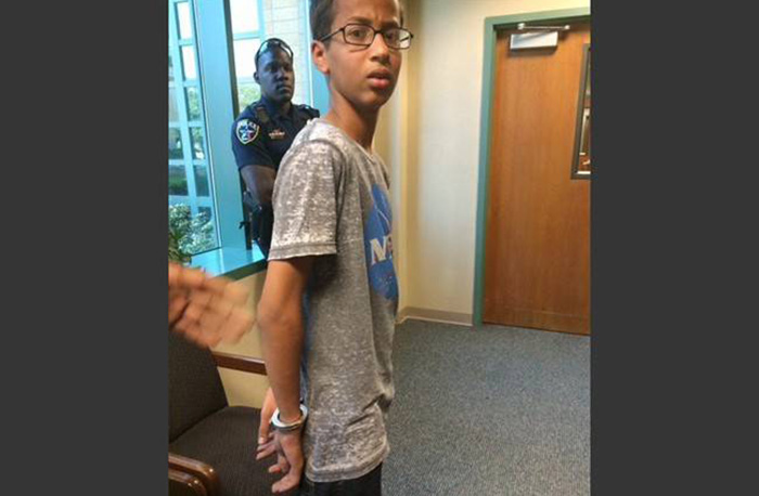 Ahmed Mohamed stands in handcuffs at Irving police department in Irving, Texas. 
