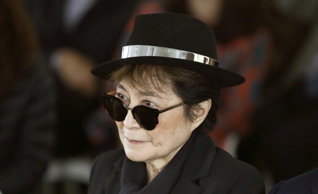 In a Friday, June 12, 2015 file photo, artist Yoko Ono appears during a ceremony announcing the future installation of Ono's first permanent public art installation in the U.S., in Chicago. Ono was hospitalized Friday, Feb. 26, 2016 for flu-like symptoms, but her representative said the singer was on the mend and should be released soon.