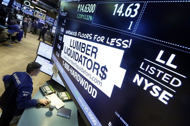 In this Monday, Feb. 1, 2016, file photo, specialist Anthony Rinaldi works on the trading floor of the New York Stock Exchange, adjacent to the post that handles Lumber Liquidators. 