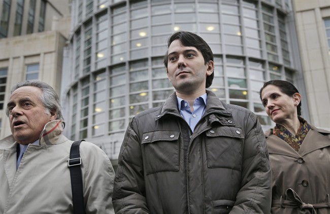 Former Turing Pharmaceuticals CEO Martin Shkreli, center, listens as his lawyer Benjamin Brafman, left, speaks to reporters as they leave court in New York, Wednesday, Feb. 3, 2016.