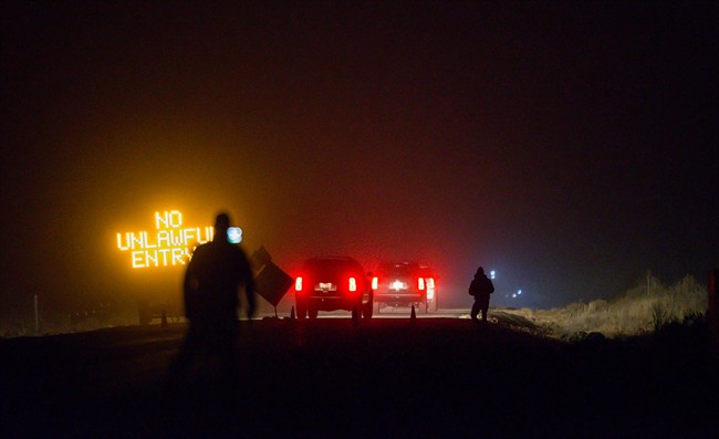 Three SUV proceeds through the Narrows roadblock near Burns, Ore., as FBI agents have surrounded the remaining four occupiers at the Malheur National Wildlife Refuge, on Wednesday, Feb.10, 2016. The four are the last remnants of an armed group that seized the Malheur National Wildlife Refuge on Jan. 2 to oppose federal land-use policies. (Thomas Boyd/The Oregonian via AP).