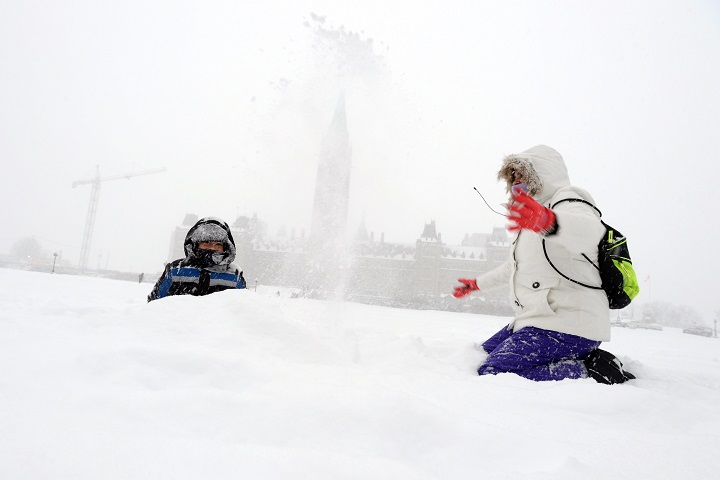 Brandon, 5, from Miami experieces snow for the first time as he plays with his mom on Parliament Hill as a major winter storm hits Ottawa on Tuesday, Feb. 16, 2016. 