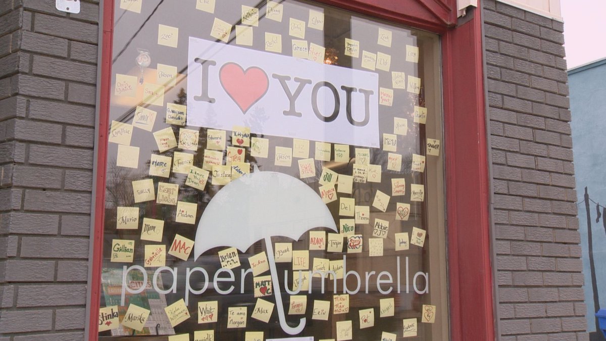 Hundreds of love notes line window at Paper Umbrella .