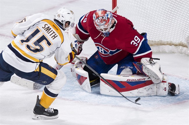 Nashville Predators' Craig Smith (15) scores past Montreal Canadiens goalie Mike Condon during NHL hockey shootout action.