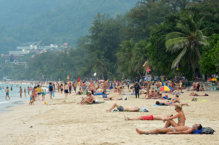 Foreign tourists relax at Patong beach in Phuket, Thailand in this on December 2014 fie photo. 