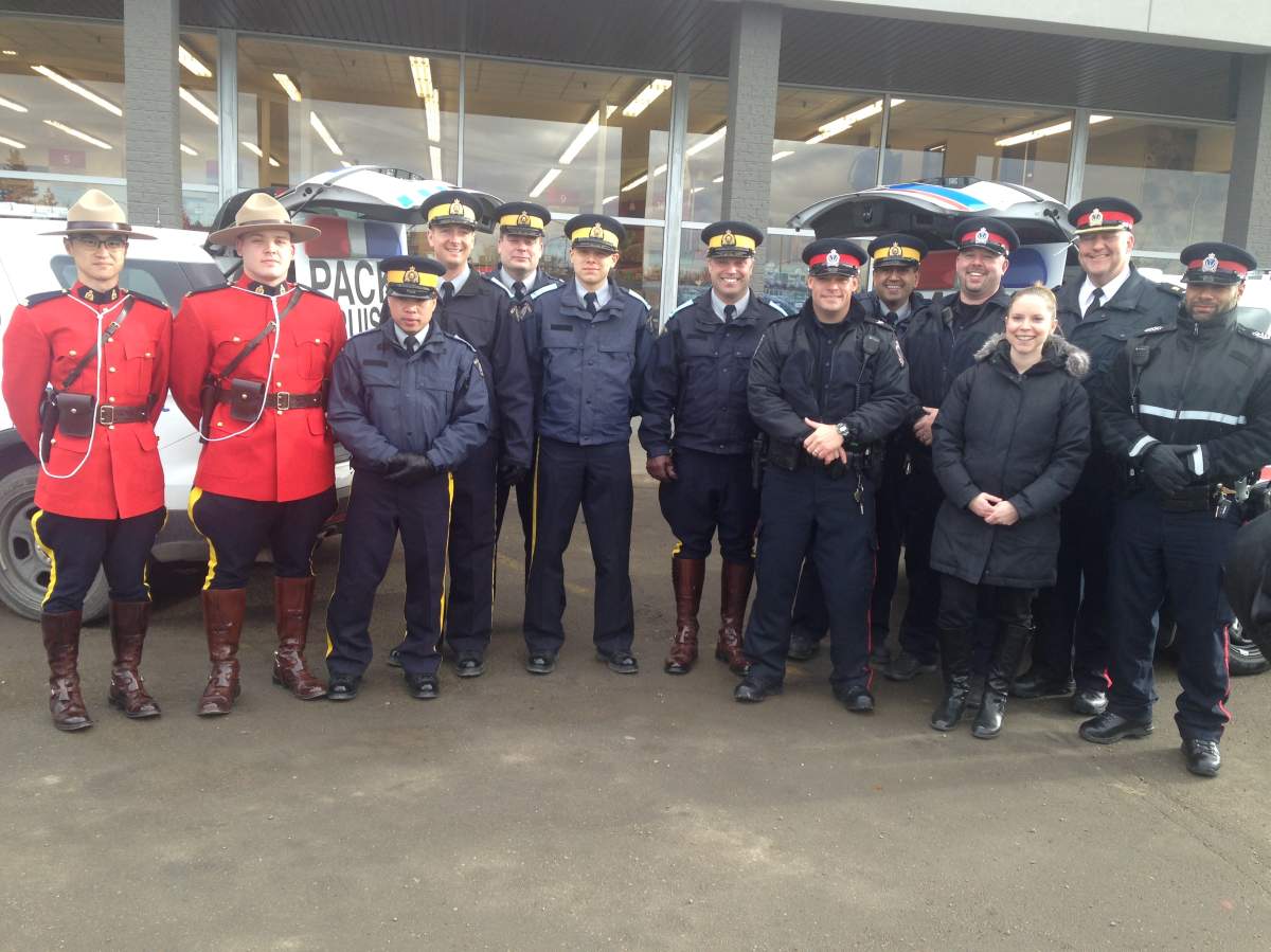 Members of the Regina Police Service and the RCMP pose for a photo.