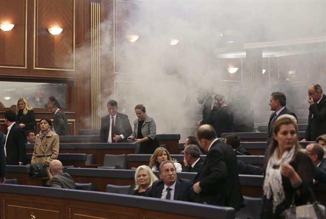 Smoke fills the auditorium of the Kosovo assembly after opposition lawmakers released tear gas canisters disrupting a parliamentary session in Kosovo capital Pristina on Friday Feb. 26, 2016.  (AP Photo/Visar Kryeziu).