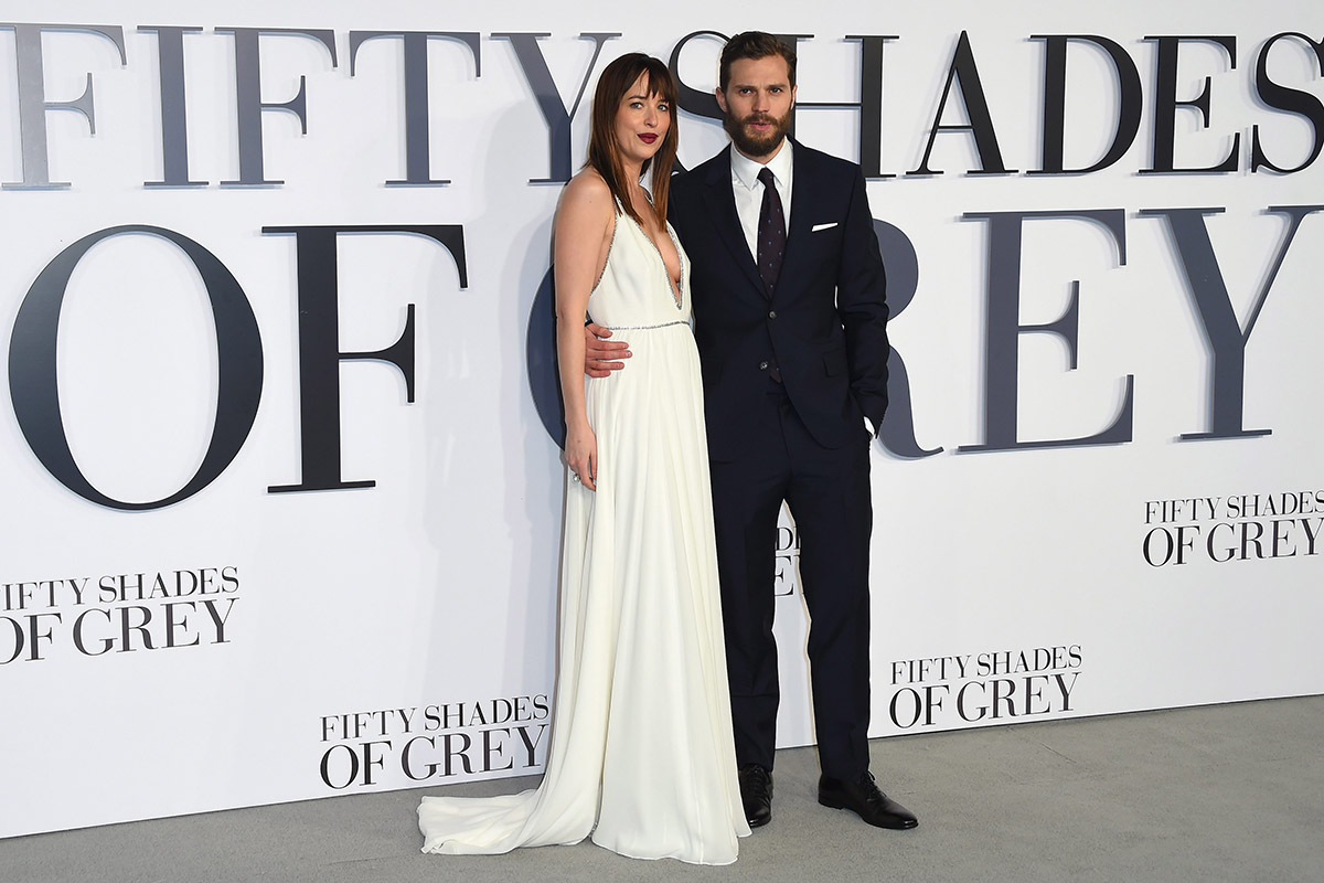 The dynamic duo, Dakota Johnson and Jamie Dornan, pose for photographers at the UK Premiere of Fifty Shades of Grey.