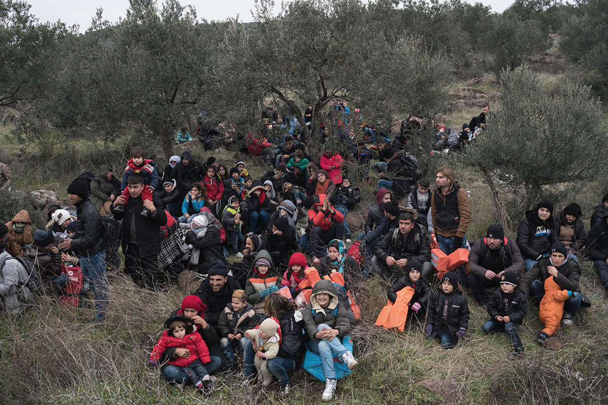 Migrants wait to travel to the Greek island of Lesbos, near the Aegean town of Ayvacik, Turkey, Friday, Jan. 29, 2016. 