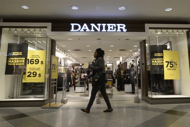 A woman walks past a Danier store in Montreal. 