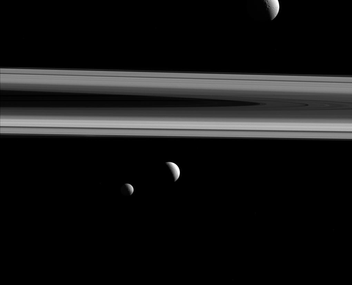 Three of Saturn's moons —Tethys, Enceladus and Mimas — are seen here.