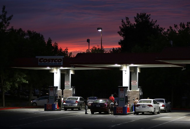 Motorists get gas at a Costco station in Sacramento, Calif.