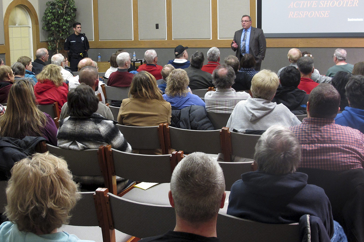In this Thursday, Jan. 28, 2016 photo, Westerville police chief Joe Morbitzer welcomes community members to a first-ever class about reacting to and surviving an active shooter, while speaking in Westerville, Ohio. 