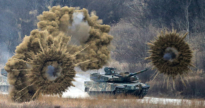 Smoke bombs explode near a South Korean army K-2 tank during a live firing drill at a training field in Yangpyeong, South Korea, on Thursday, Feb. 18, 2016. North Korean leader Kim Jong Un recently ordered preparations for launching "terror" attacks on South Koreans, a top Seoul official said Thursday. 