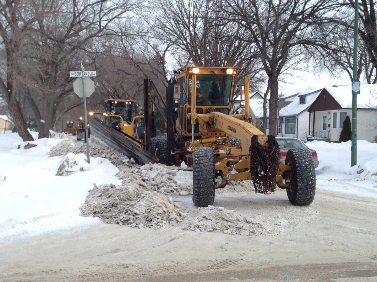 A snow plow tackles Winnipeg streets. 
