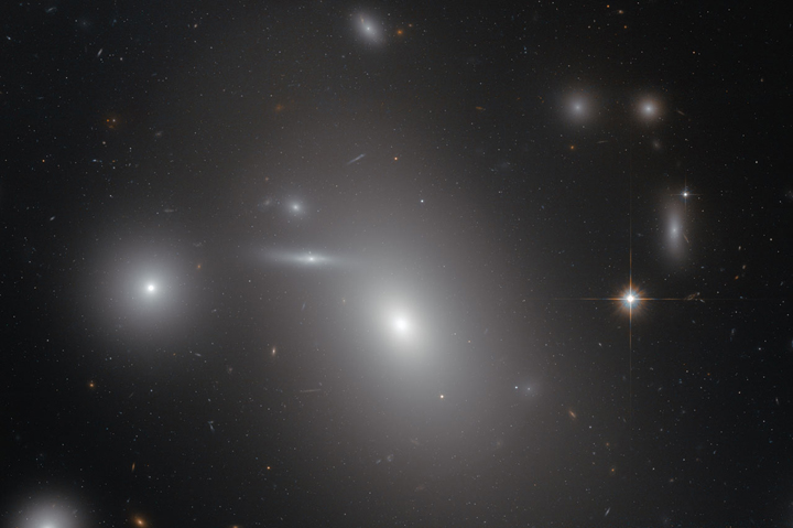 Hidden from human eyes is a supermassive black hole within this elliptical galaxy, NGC 4889.