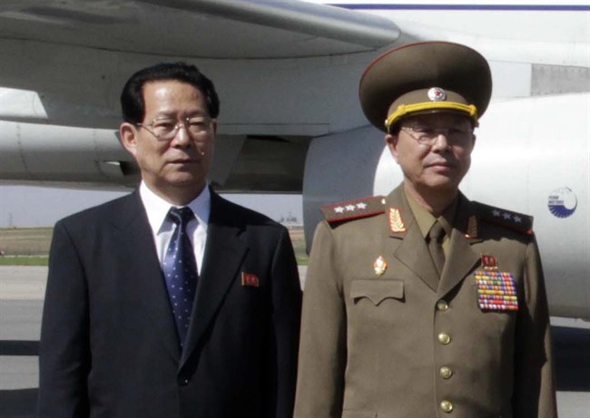 FILE - In this May 22, 2013 file photo, Kim Hyong Jun, deputy minister Foreign Affairs, Ri Yong Gil, col. gen. of the Korean People's Army, pose before leaving Pyongyang Airport in North Korea for China.