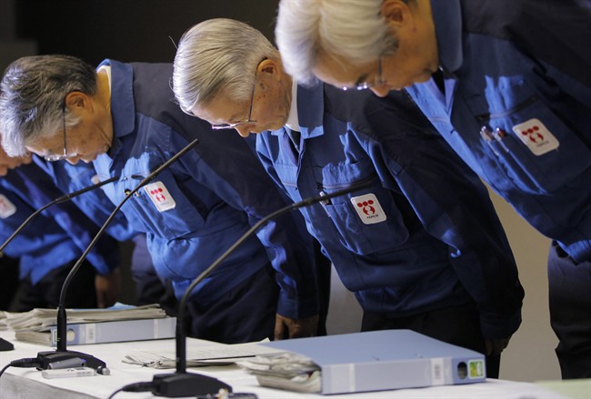 FILE - In this March 30, 2011, file photo, Tokyo Electric Power Co., (TEPCO) then Chairman Tsunehisa Katsumata, center, with then Vice President Sakae Muto, right, bows before a news conference at the company's head office in Tokyo. Three former Japanese utility executives, including Katsumata and Muto, were formally charged for alleged negligence in the Fukushima nuclear disaster Monday, Feb. 29, 2016, becoming the first ones from the company to face a criminal court. (AP Photo/Itsuo Inouye, File).