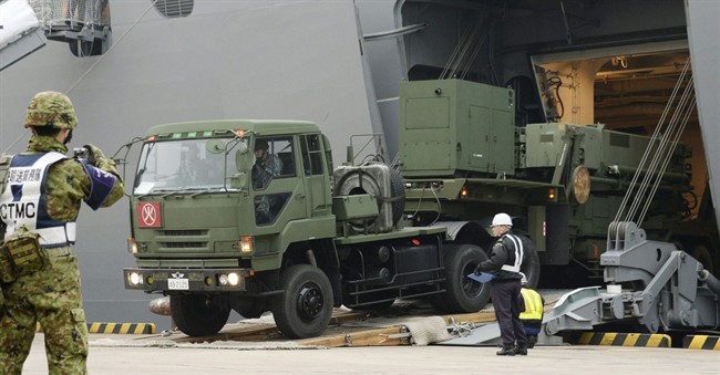 A vehicle carrying a PAC-3 missile interceptor arrives at a port on Ishigaki Island, Okinawa prefecture, southwestern Japan Saturday, Feb. 6, 2016. North Korea has moved up the window of its planned long-range rocket launch to Feb. 7-14, South Korea's Defense Ministry said Saturday. The launch, which the North says is an effort to send a satellite into orbit, would be in defiance of repeated warnings by outside governments who suspect it is a banned test of ballistic missile technology.