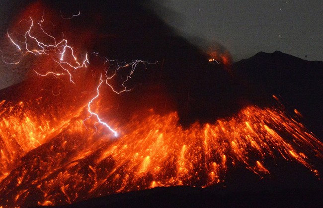 Lightning flashes above flowing lava as Sakurajima, a well-known volcano, erupts Friday evening in southern Japan. Japan's Meteorological Agency said Sakurajima on the island of Kyushu erupted at around 7 p.m. (1000 GMT). (Kyodo News via AP) .