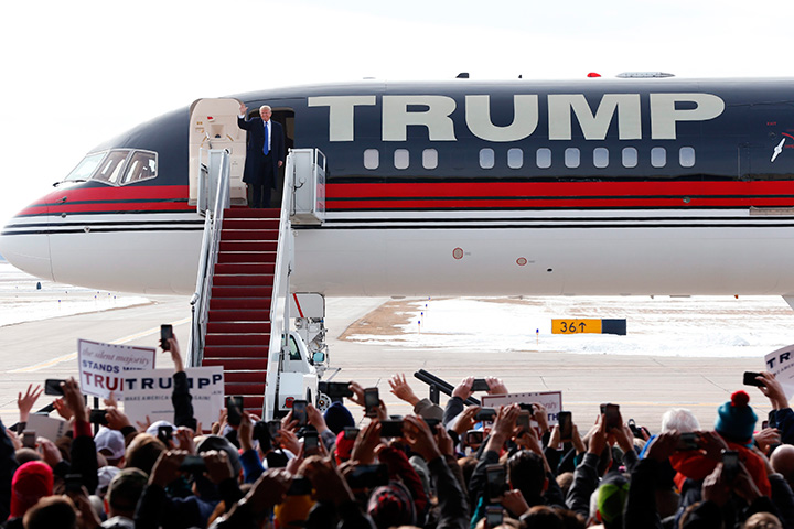 Republican presidential candidate Donald Trump waves as he arrives at a campaign event at Dubuque Regional Airport, Saturday, Jan. 30, 2016 in Dubuque, Iowa. 