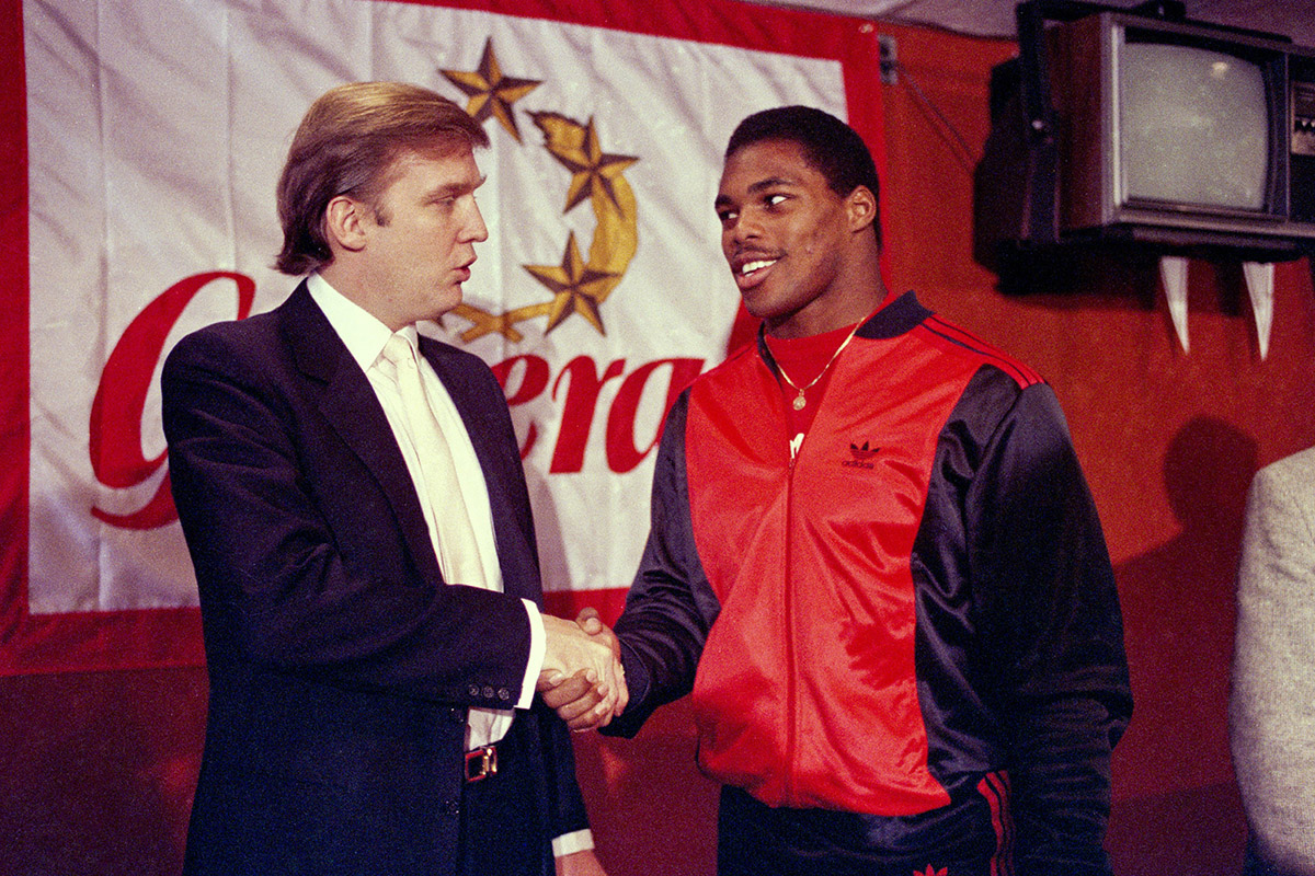  In this March 8, 1984, file photo, Donald Trump shakes hands with Herschel Walker in New York after agreement on a 4-year contract with the New Jersey Generals USFL football team. 