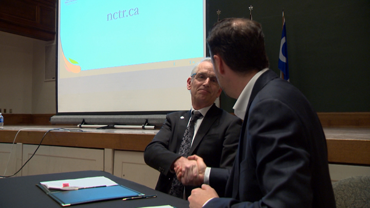 University of Saskatchewan president Peter Stoicheff (left) and Ry Moran, director of the National Centre for Truth and Reconciliation, shake hands as the U of S joins eight other post-secondary institutions in partnering with the centre.