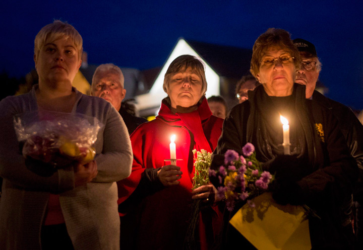 Mourners hold a candlelit vigil in remembrance of Carol Culleton, Anastasia Kuzyk and Nathalie Warmerdam in Wilno