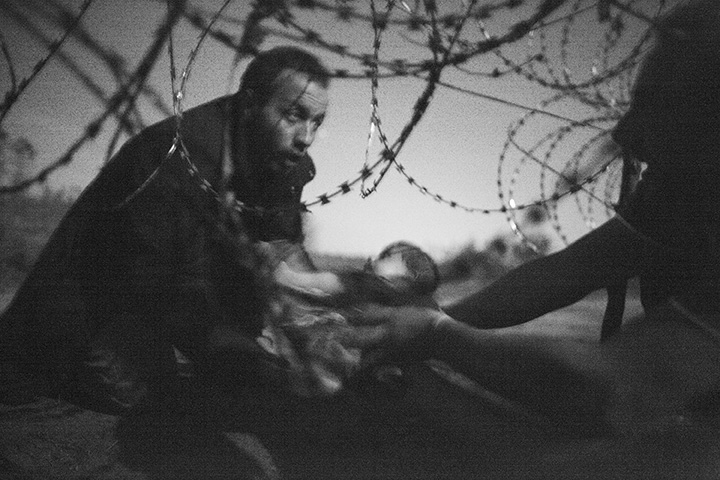 Warren Richardson has won the World Press Photo of the Year for this image titled "Hope for a new Life." The image also won a first prize in the Spot News singles category and shows a man passing a baby through the fence at the Serbia-Hungary border in Roszke, Hungary, Aug. 28, 2015.