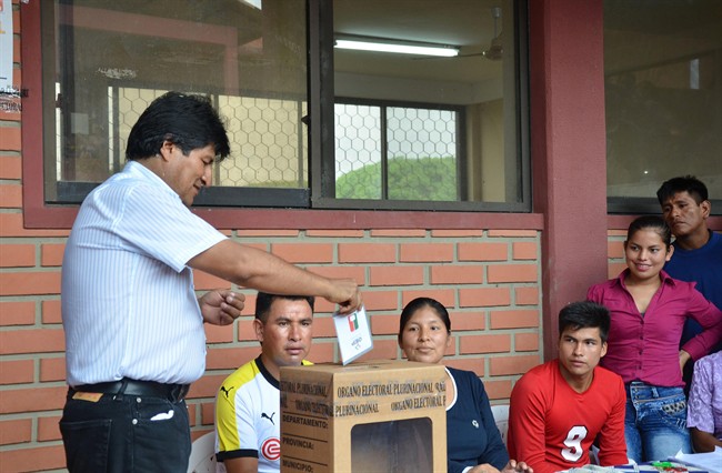 Bolivia's President Evo Morales, left, casts his ballot at a polling station in Villa 14 de Septiembre, in the Chapare region, Bolivia, Sunday, Feb. 21, 2016. Bolivians are voting in a referendum on whether to amend the constitution so that President Morales can run in 2019 for a fourth consecutive term.