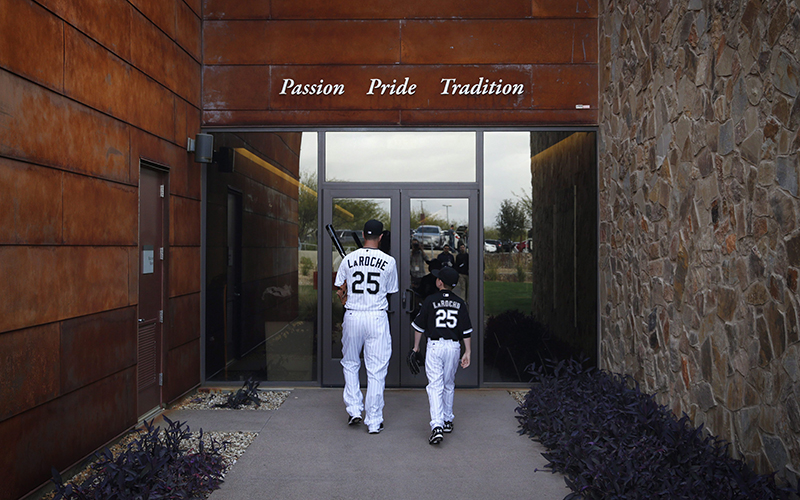 Chicago White Sox's Adam LaRoche, left, and his son Drake walk into the White Sox clubhouse during a photo day before a baseball spring training workout, Saturday, Feb. 28, 2015 in Phoenix.