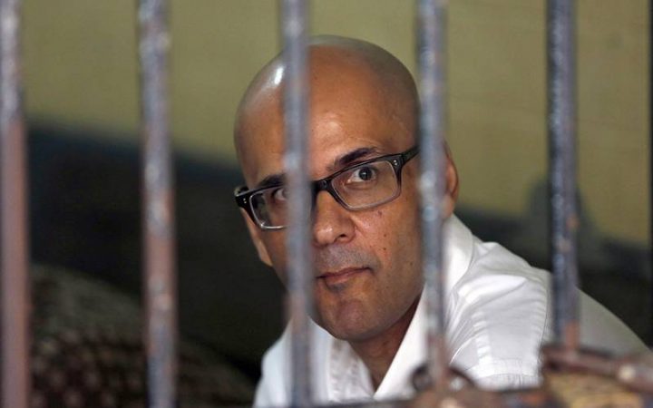 Canadian teacher Neil Bantleman sits inside a holding cell prior to the start of his trial hearing to listen to the prosecutor's demand at South Jakarta District Court in Jakarta, Indonesia, March 12, 2015. THE CANADIAN PRESS/AP, Dita Alangkara.